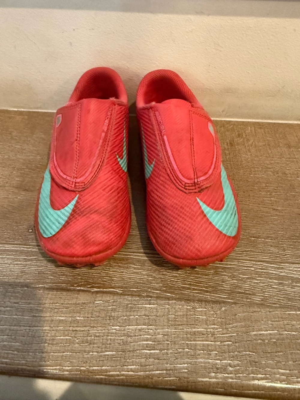 Nike Kids Red Slip-On soccer shoes Teal Swoosh